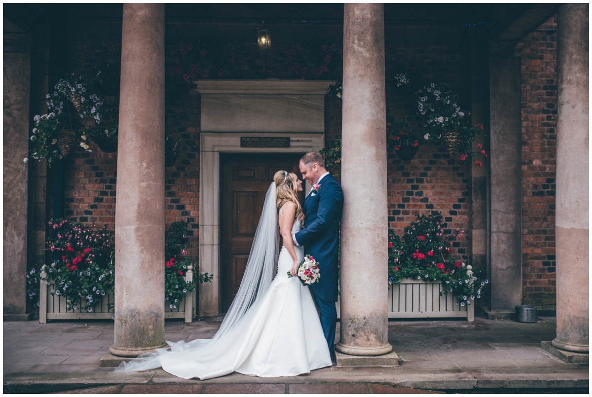 The new husband and wife share a kiss at the beautiful entrance to Willington Hall in Tarporley.