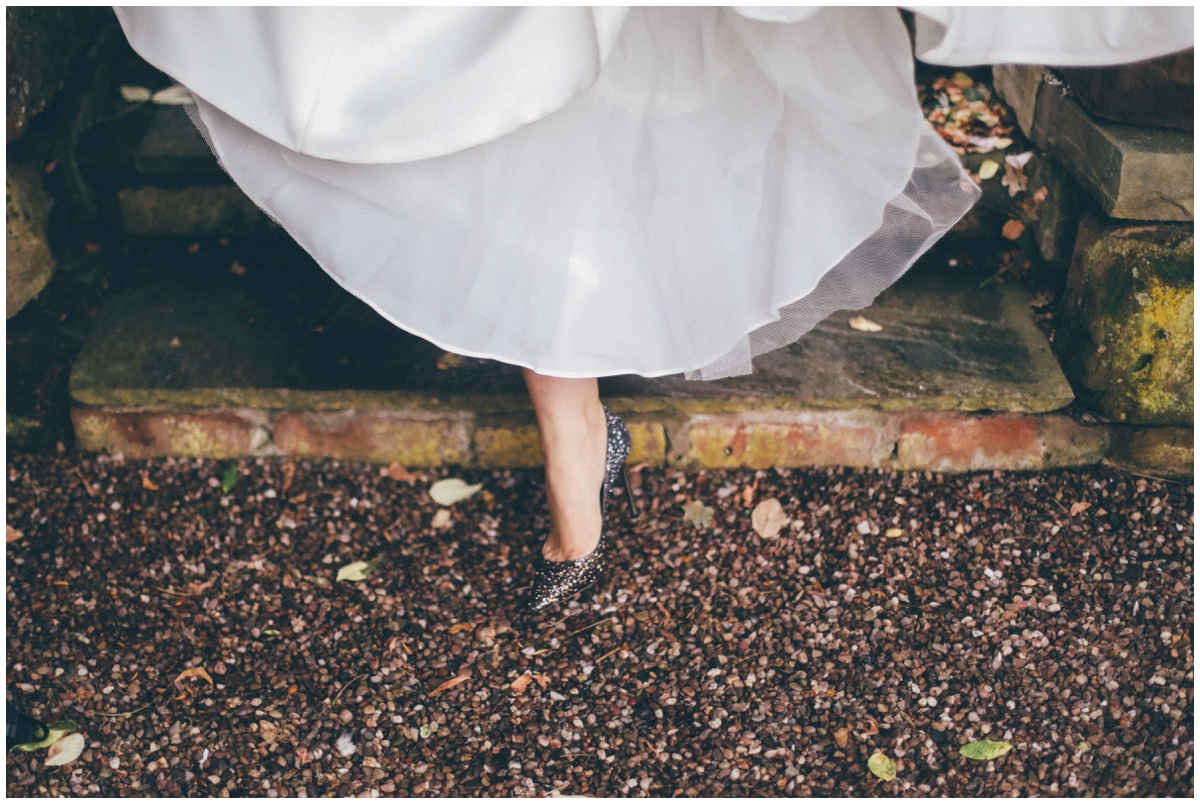 The bride takes a step in her beautiful grey Jimmy Choo bridal shoes.