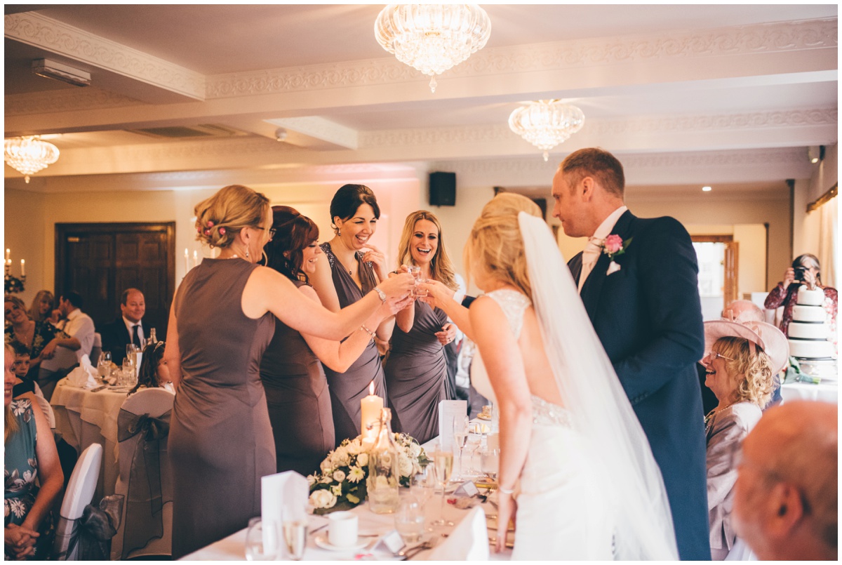 The bride does a shot of sambuca with her new husband and bridesmaids at Willington Hall during the speeches.