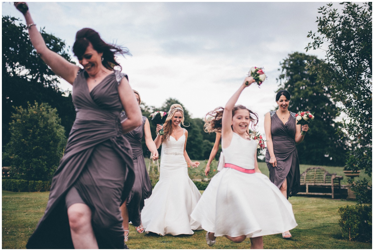 The bride has fun with her bridesmaids during her wedding at Willington Hall.