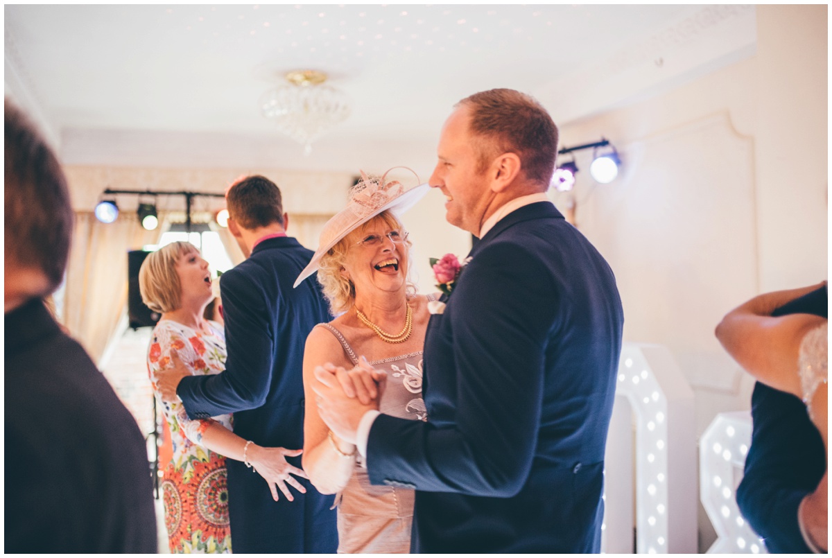 The groom dances and shares a joke with his new mother in law.