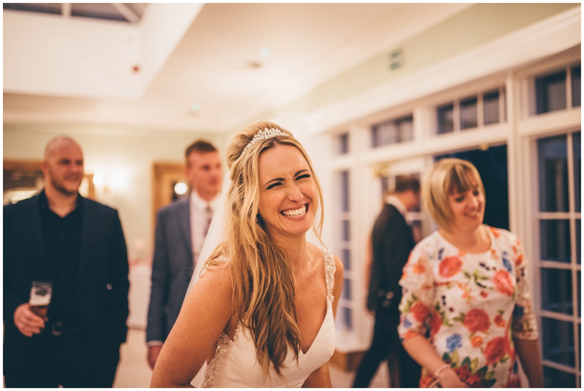 The new bride grins at her Frodsham wedding photographer at her wedding at Willington Hall in Cheshire.