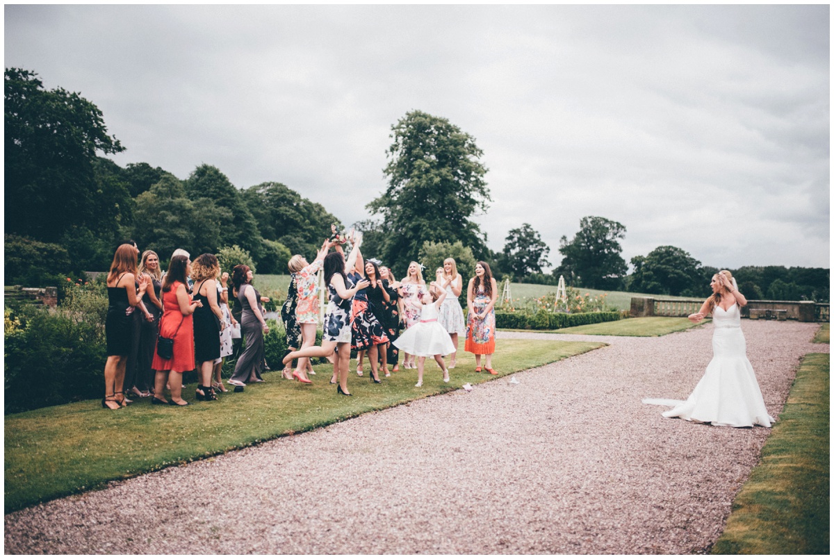 The bride tosses her bouquet at Willington Hall in Cheshire