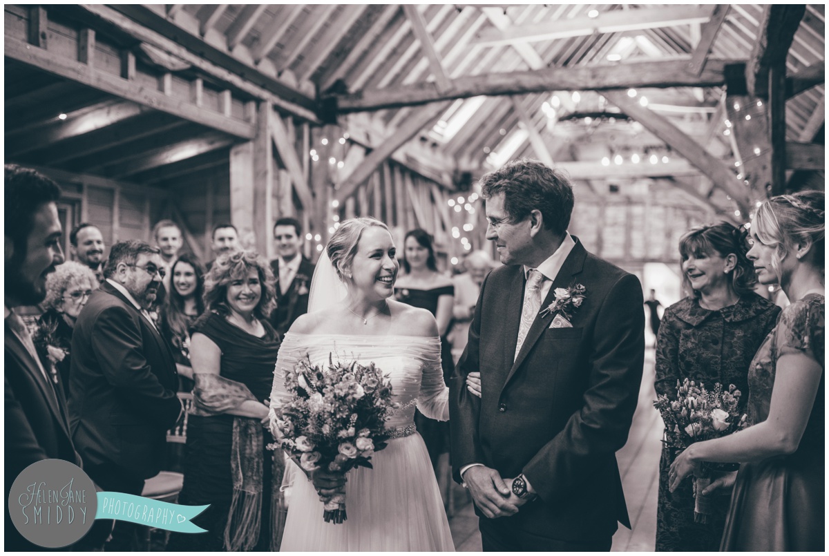 The beautiful bride is walked down the aisle by her uncle at Bassmead Manor.