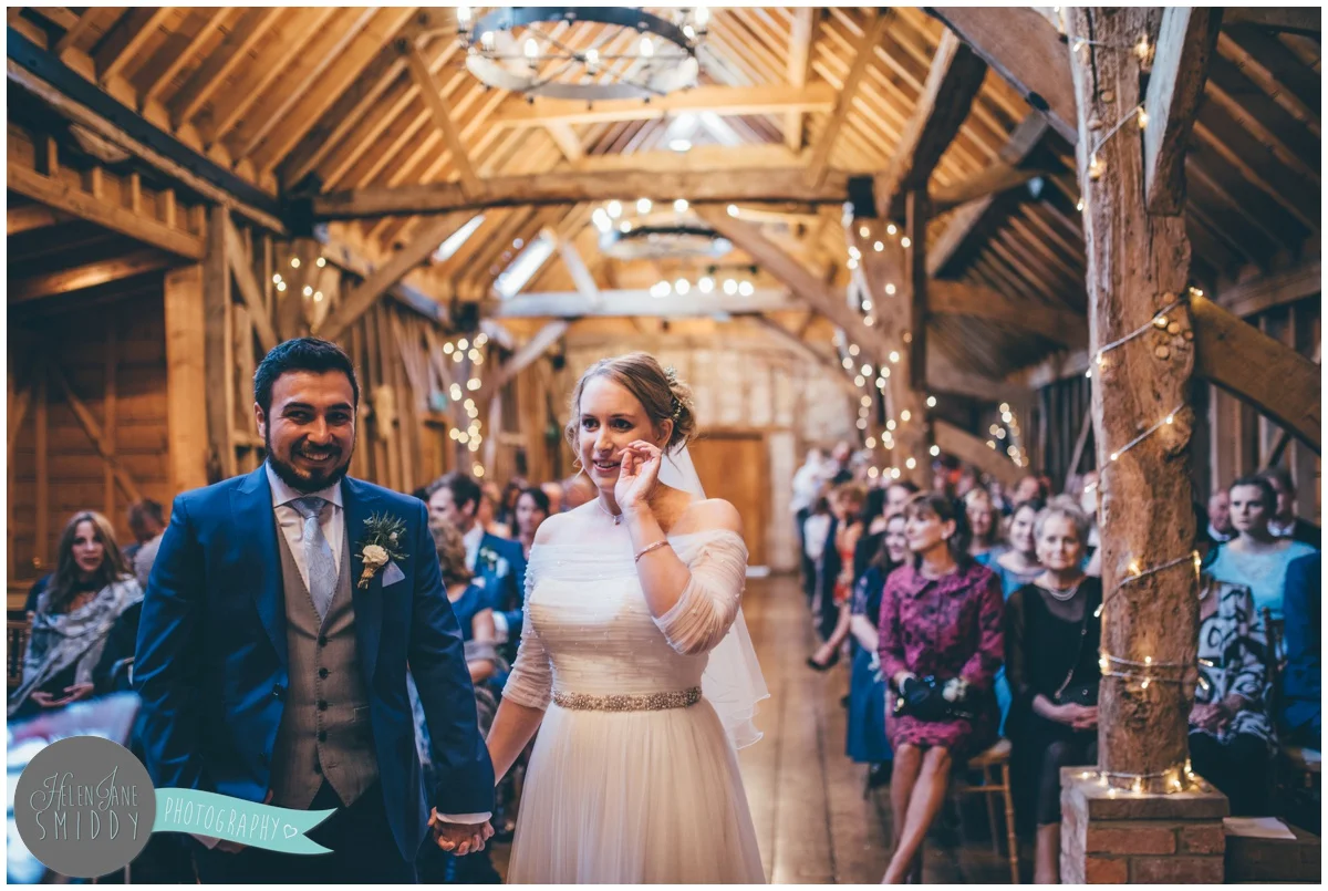 The bride and group take their vows at Bassmead Manor Barns in Cambridge.