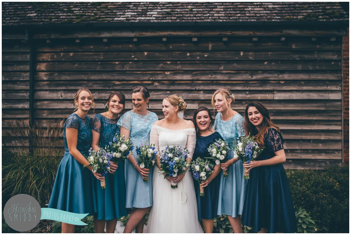 The bride enjoys time with her beautiful bridesmaids at Bassmead Manor wedding barns.