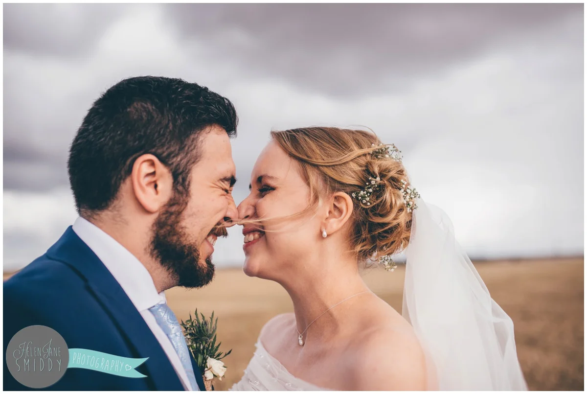 The bride and groom are so cute together as they have their wedding photographs taken.