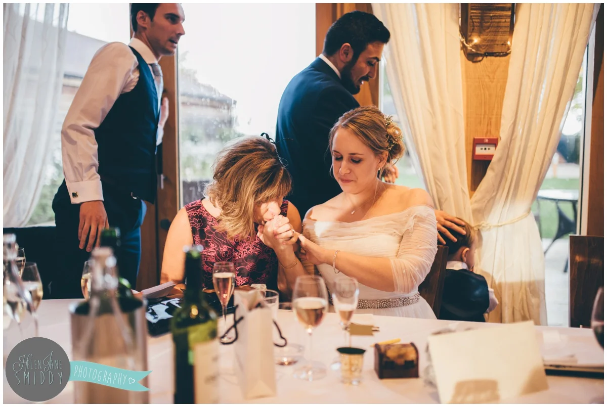 Bride and her mum share an intimate moment during Wedding speeches at Bassmead Manor wedding barns.