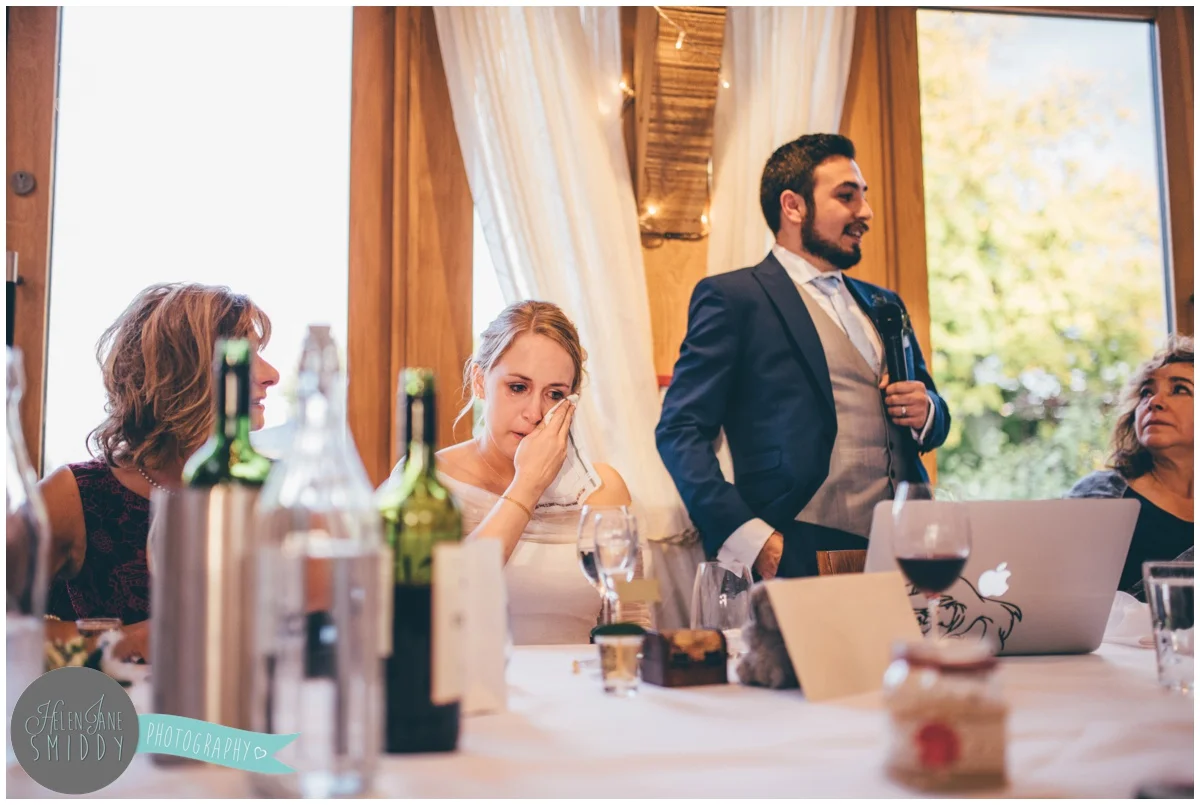 The bride tears up during the Wedding speeches at Bassmead Manor wedding barns.