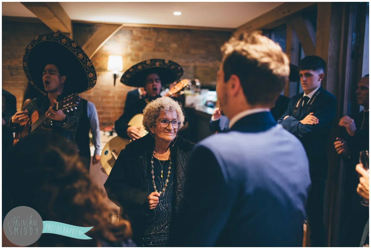 The groom's grandma enjoys the evening wedding reception with the guests.
