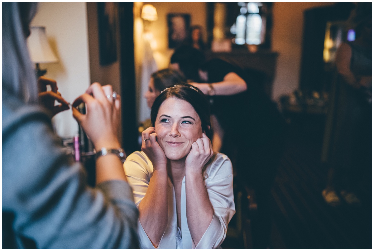 The bride covers her ears so as not to get upset and ruin her make-up.