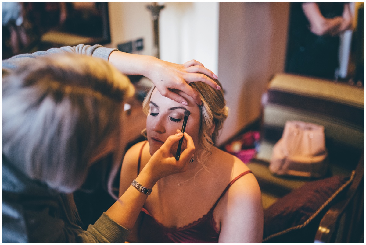 Bridesmaid recieves finishing touches to the make up.