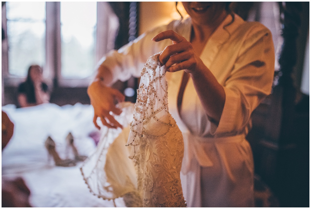 Bride starts to get into her wedding gown.
