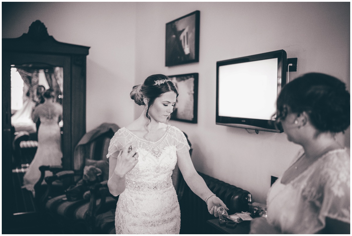 Beautiful bride sprays her perfume whilst getting ready.