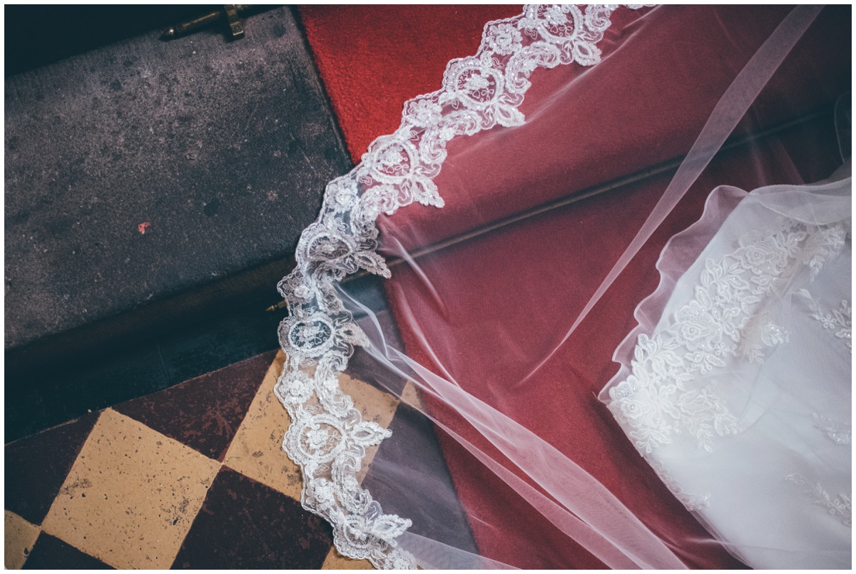 The detail on the bride's veil against the tiled floor of Peckforton Castle.