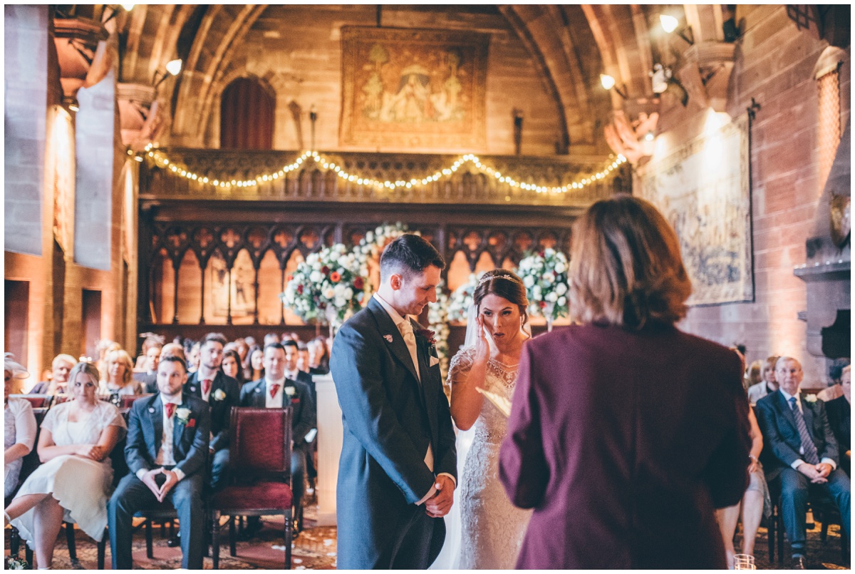 Bride gets emotional during the wedding ceremony at Peckforton Castle.