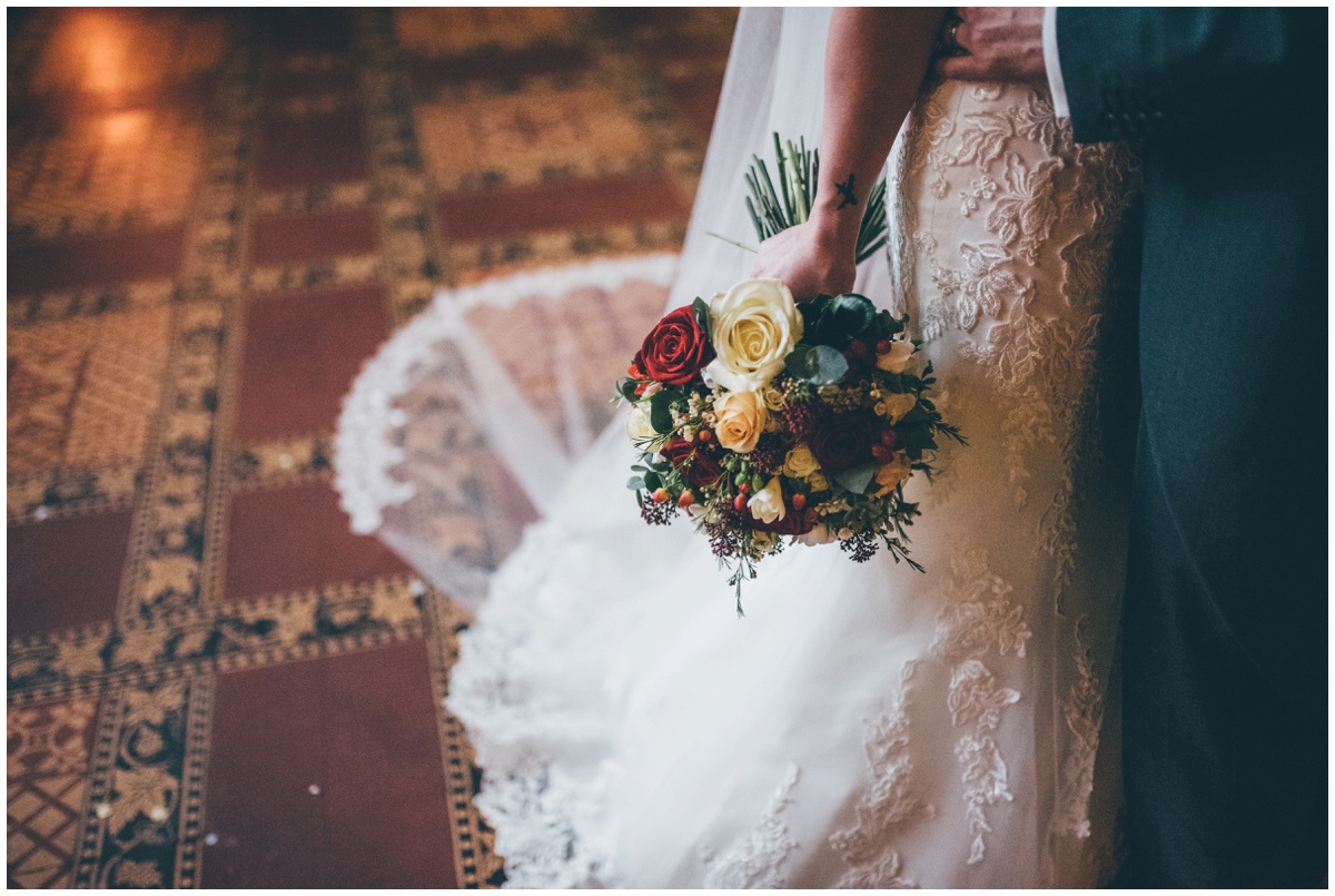 The new husband and wife have their wedding portraits taken in the Great Hall at Peckforton Castle.