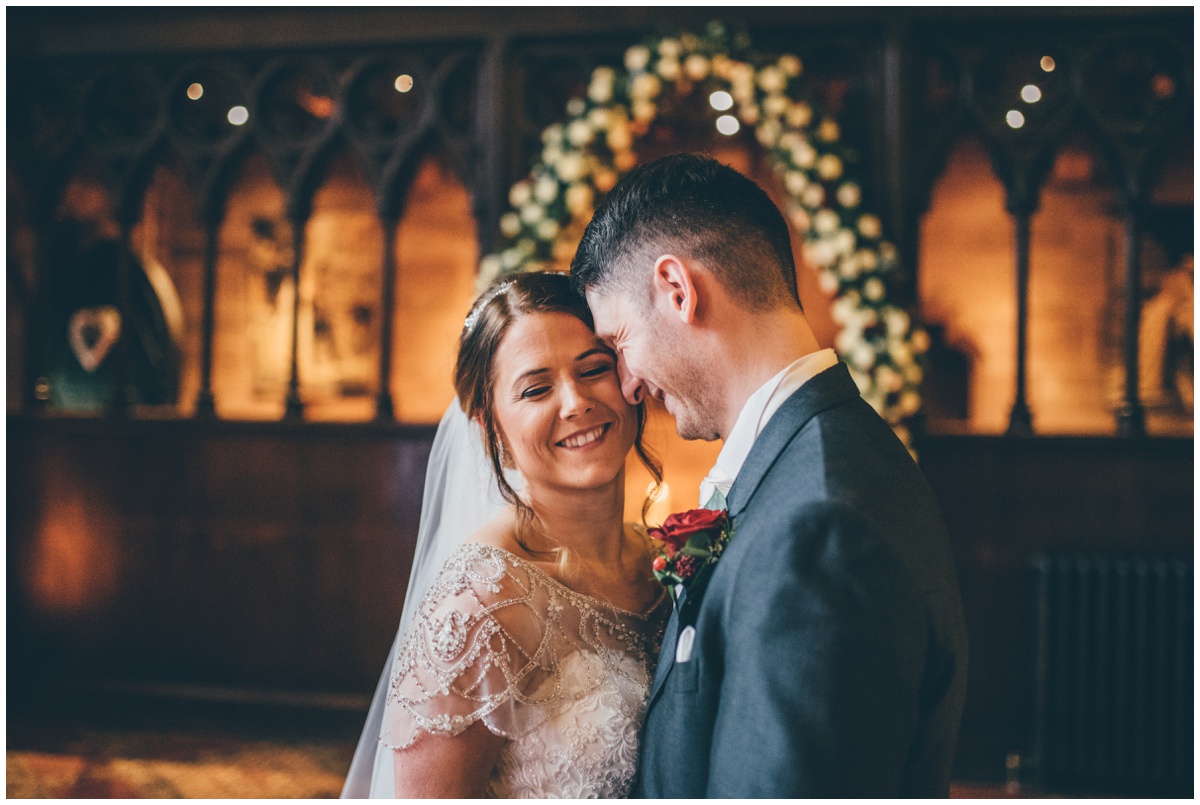 The new husband and wife have their wedding portraits taken in the Great Hall at Peckforton Castle.