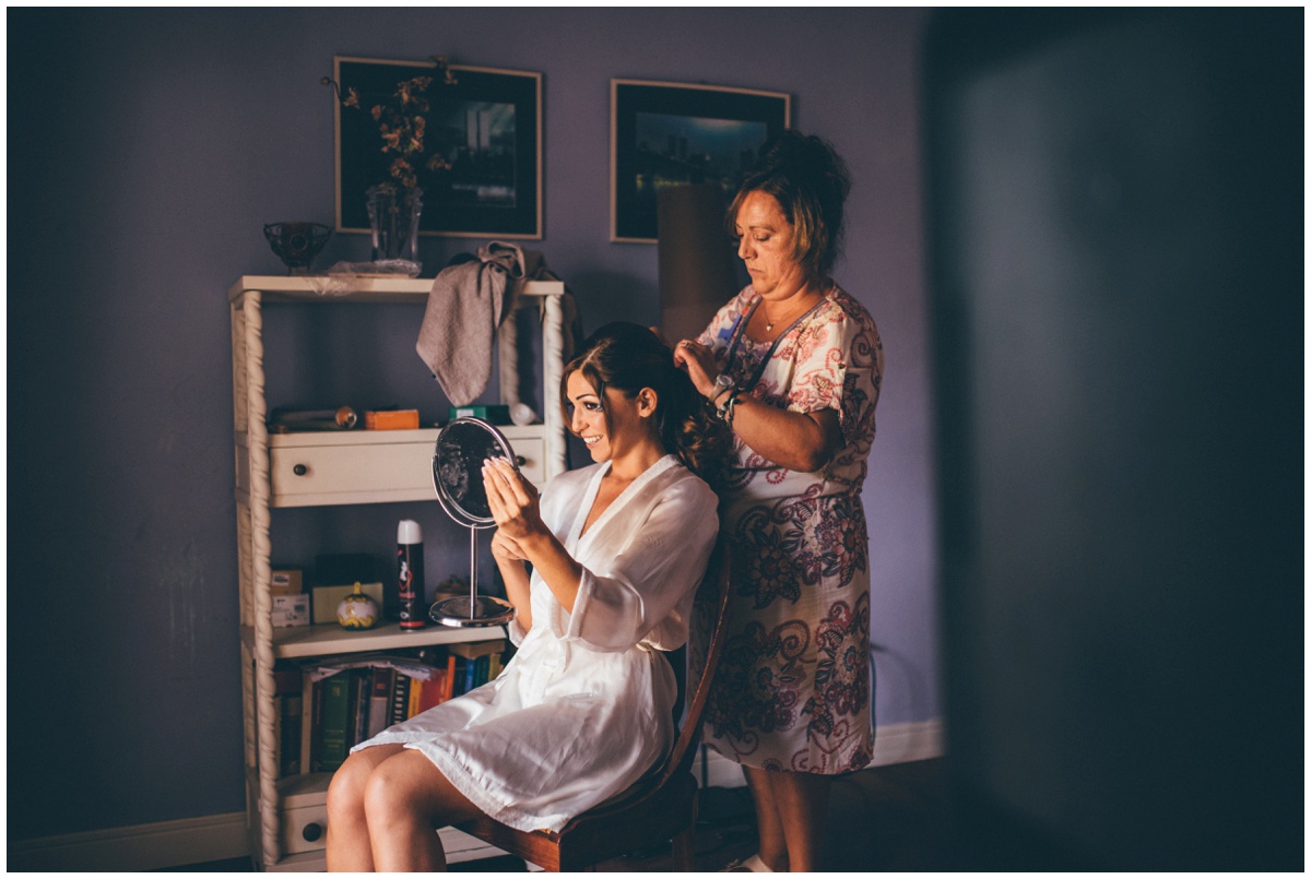 Italian bride getting her hair done on her wedding morning.