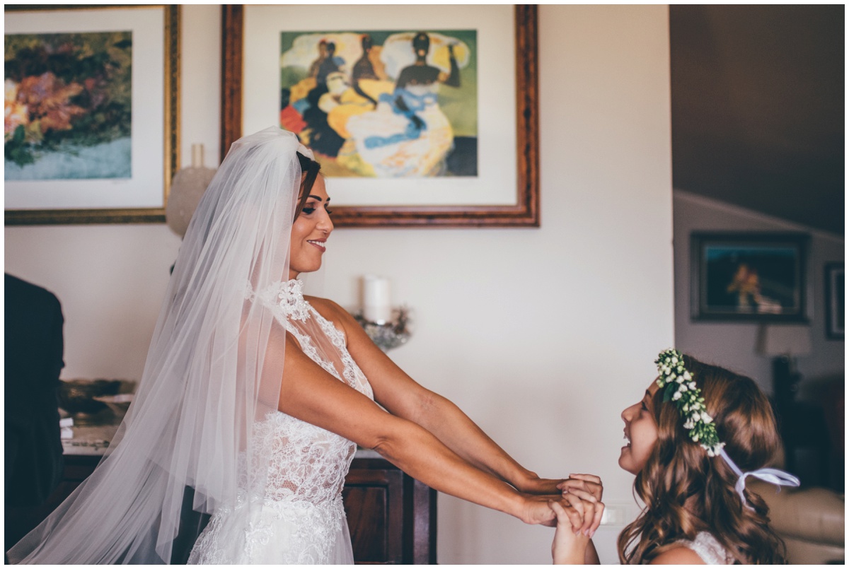 Stunning bride plays with her flowergirl.