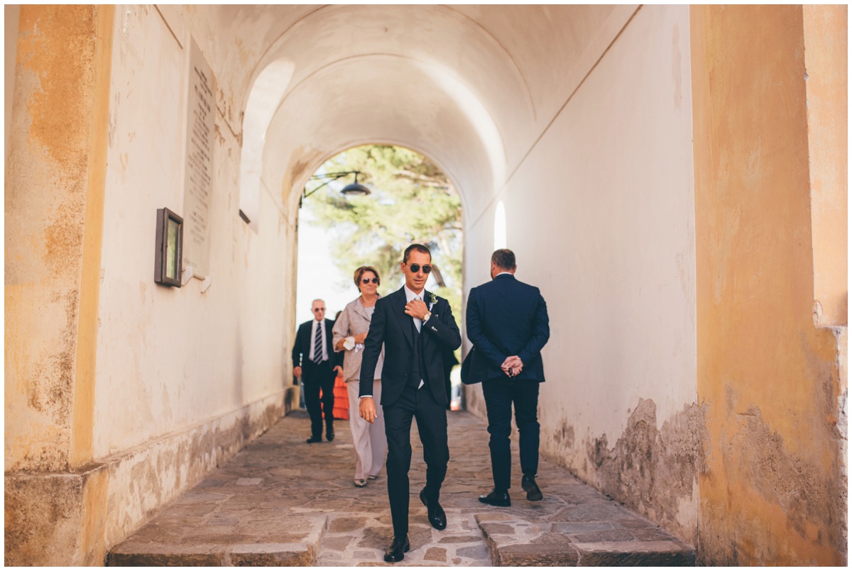 The groom and his groomsmen walk towards his wedding venue in Santa Maria di Castellabate.