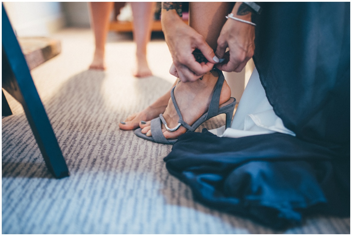 The bride fastens up her Carvela by Kurt Geiger wedding shoes.