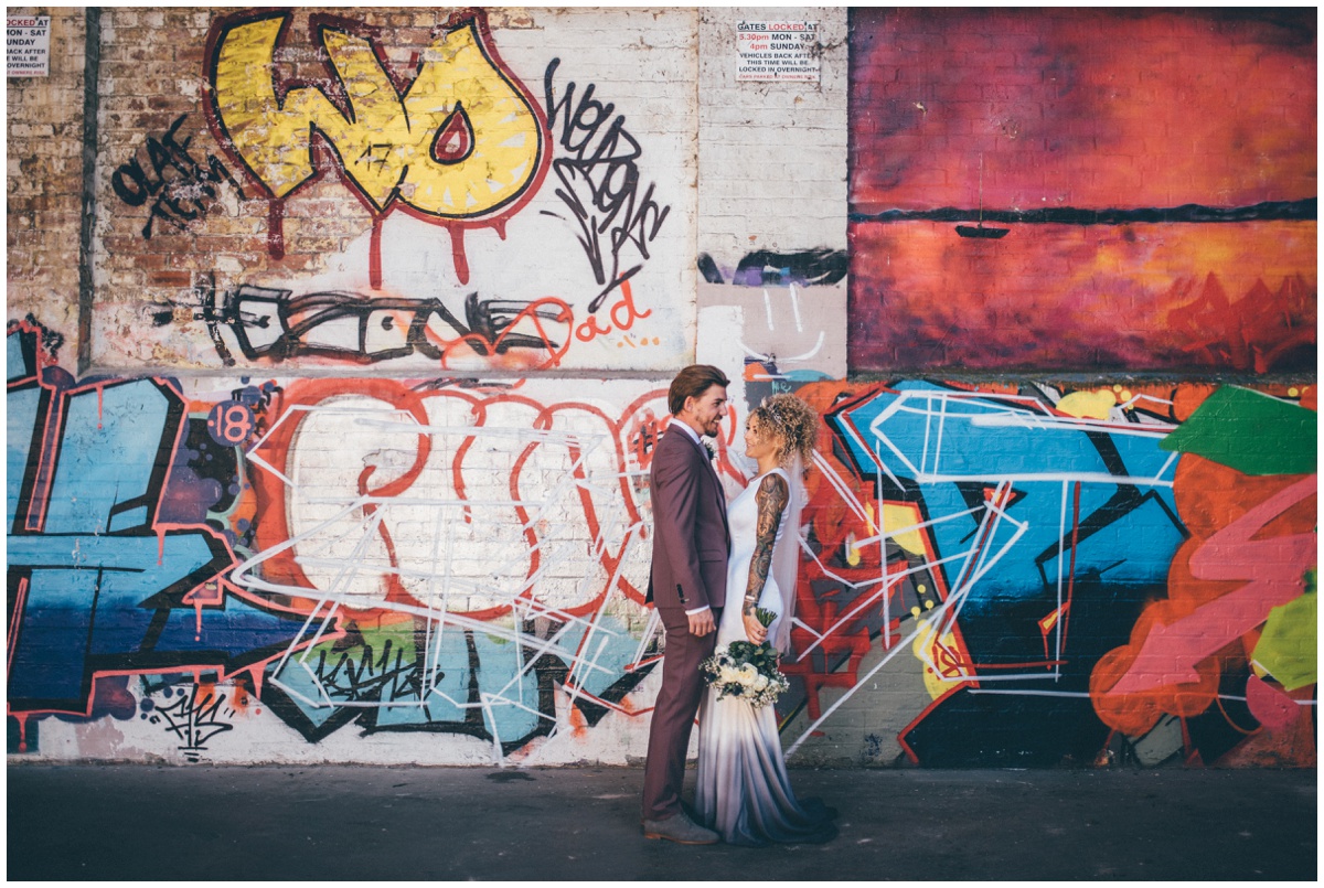 Stunning bride and groom in graffiti filled car park in Chester.