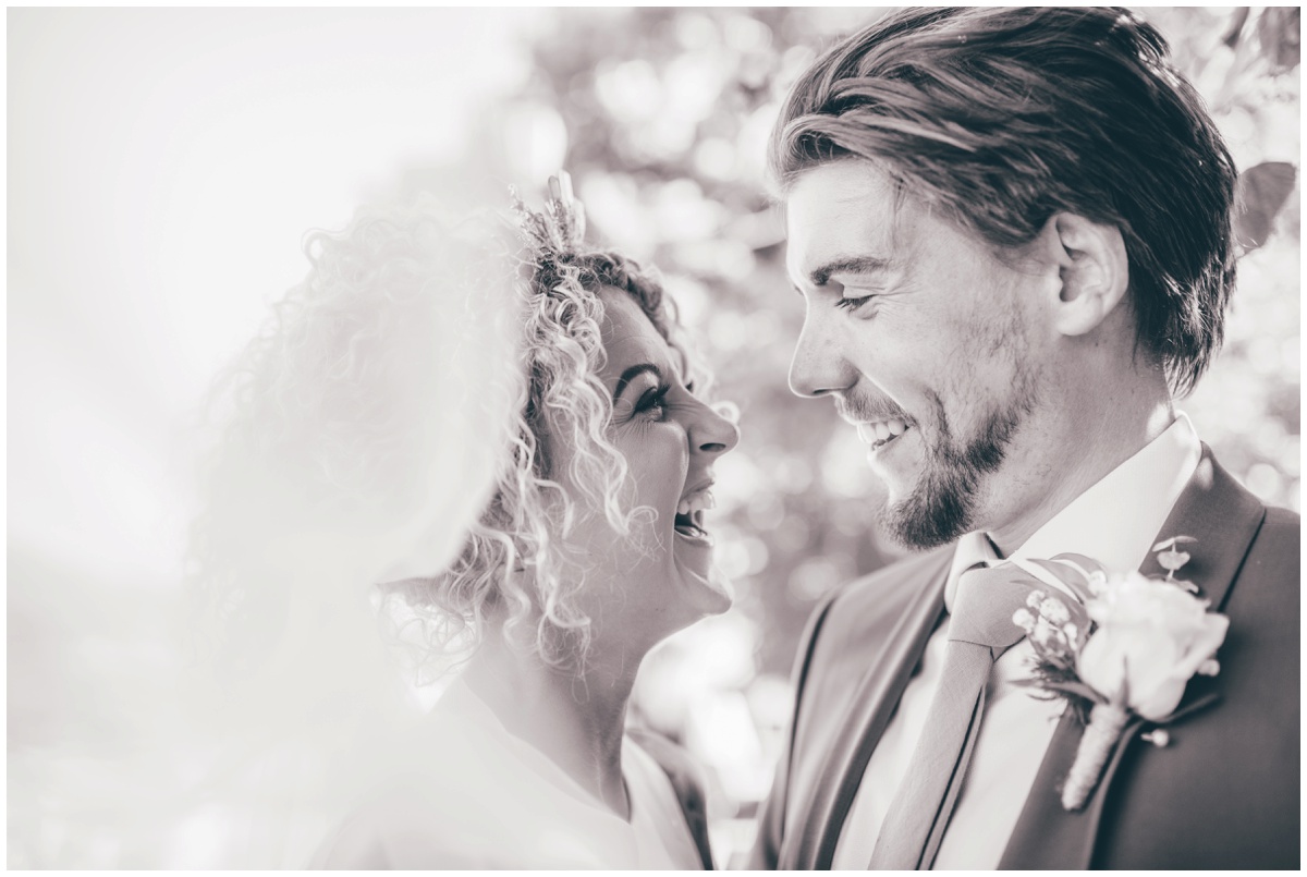 Bride and groom share a laugh on the Roman Walls in Chester.