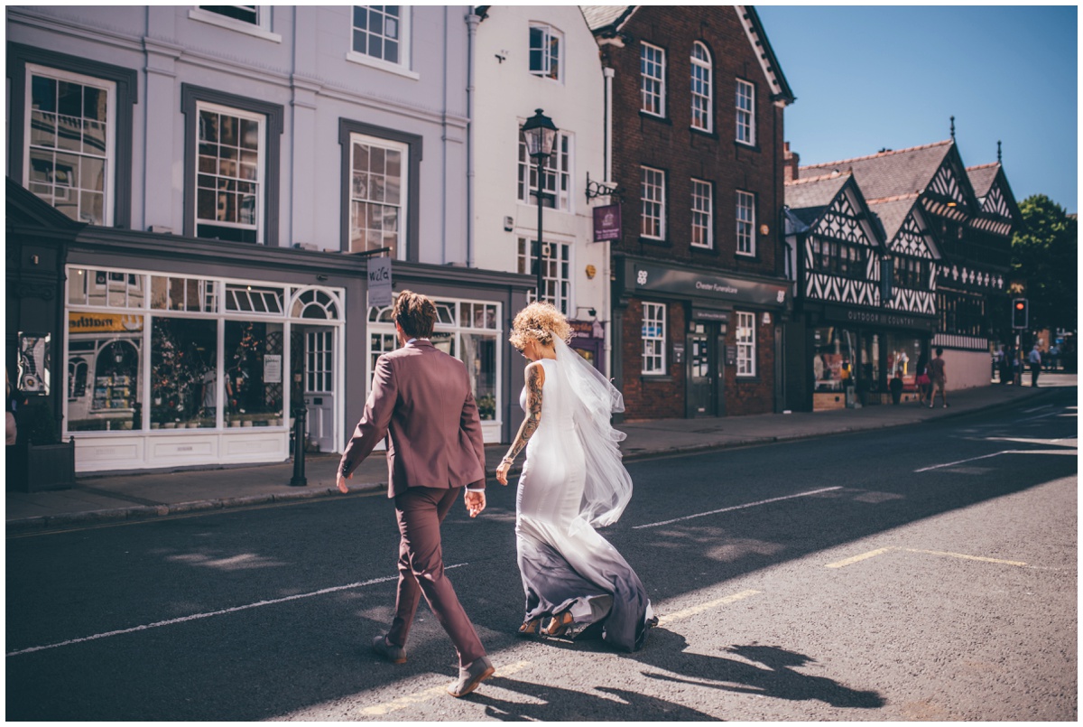 Bride and groom cross the road in Chester towards Oddfellows.