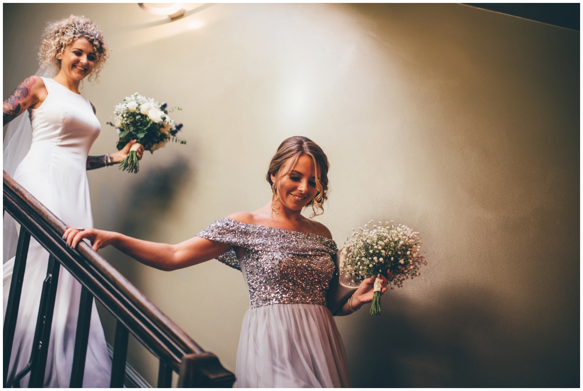 The Bride and her bridesmaid walk down the stairs at Oddfellows in chester.