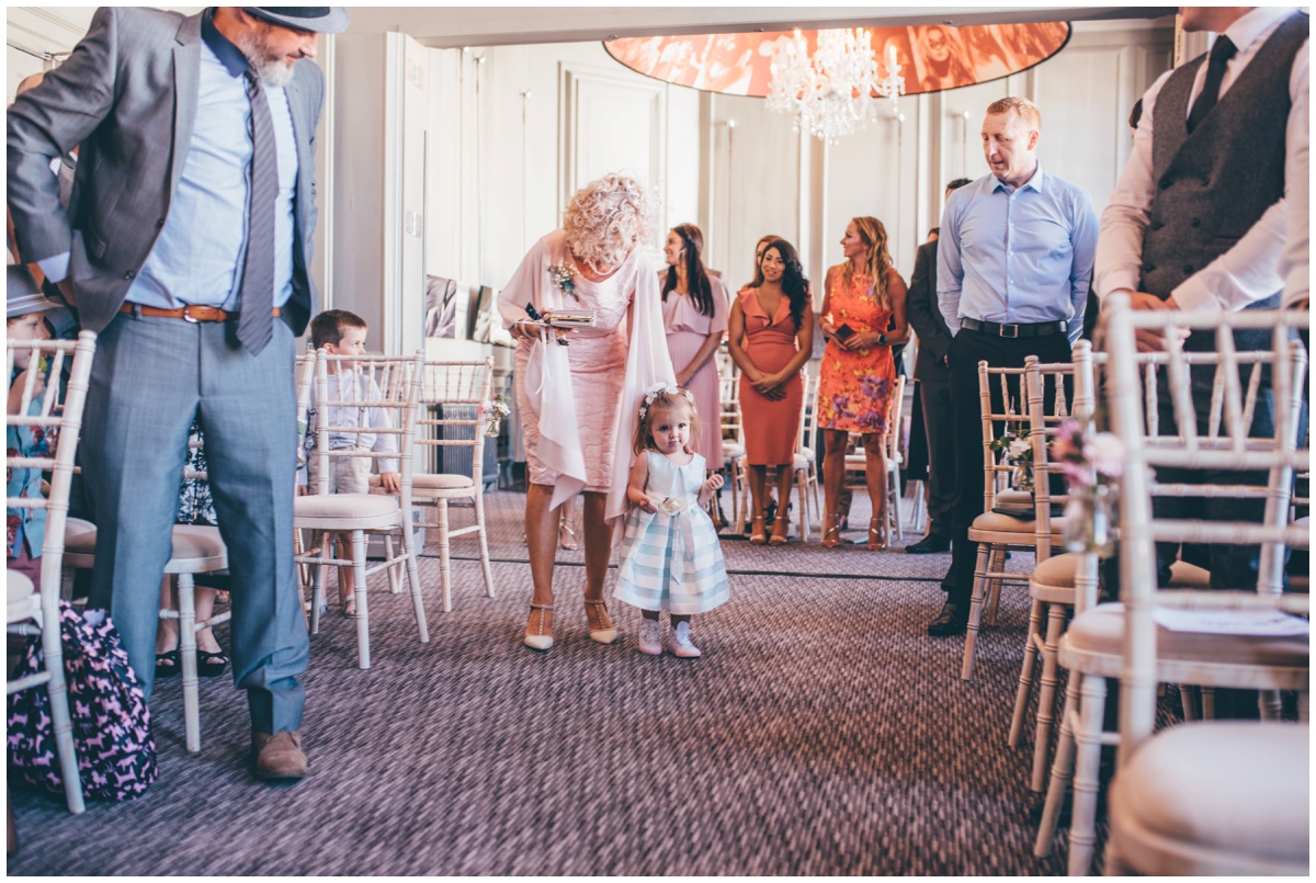 Flowergirl walks down the aisle with mother of the bride at Oddfellows in Chester.