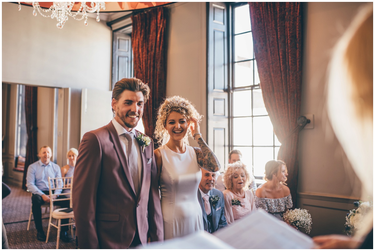 Bride and Groom beaming before their wedding vows.