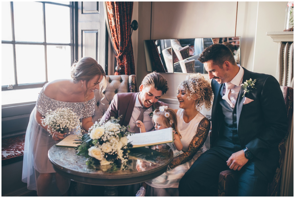 Newlyweds and their witness laugh after the register signing in Oddfellows in Chester.