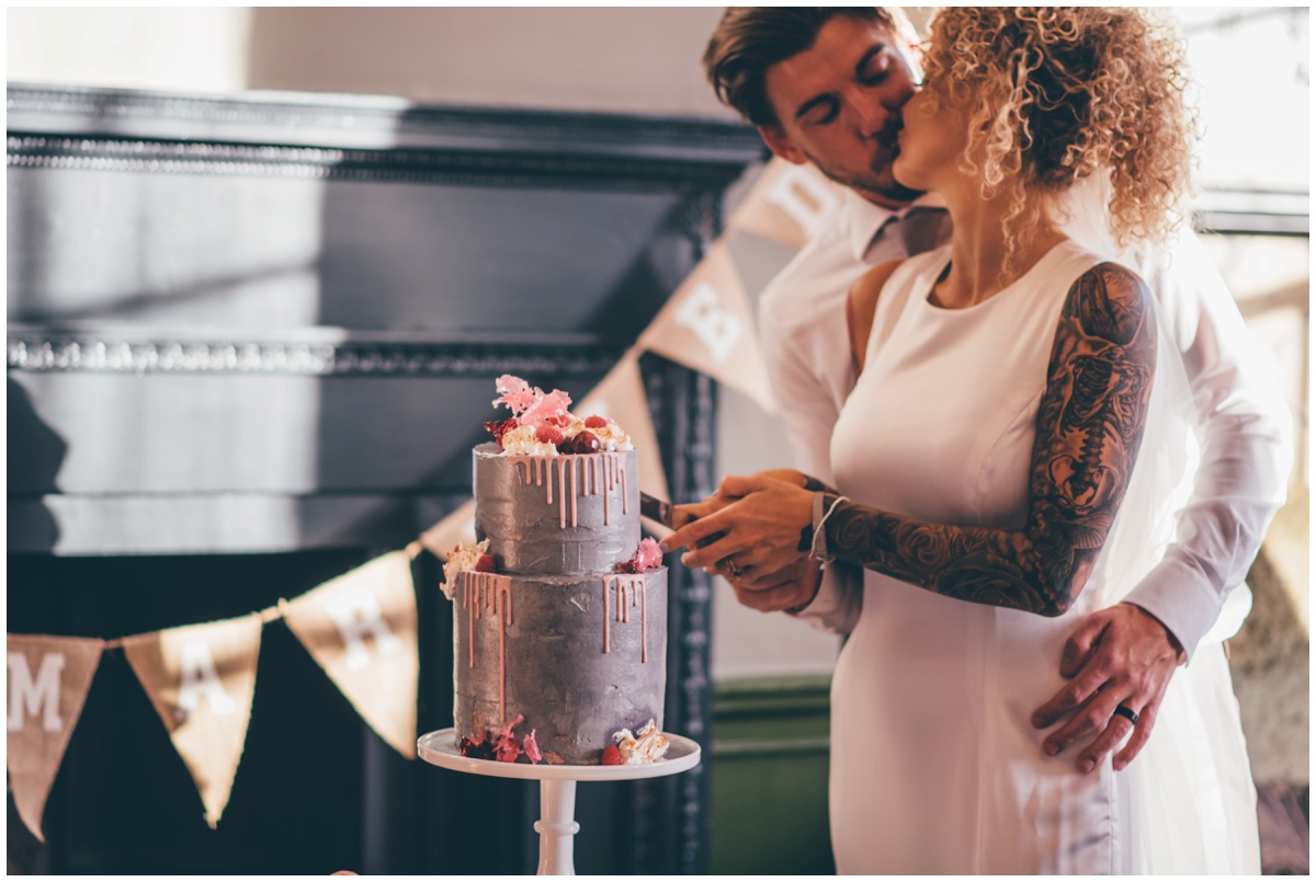 Pink and grey drip cake with isomalt flames by Ben Read Cakes.