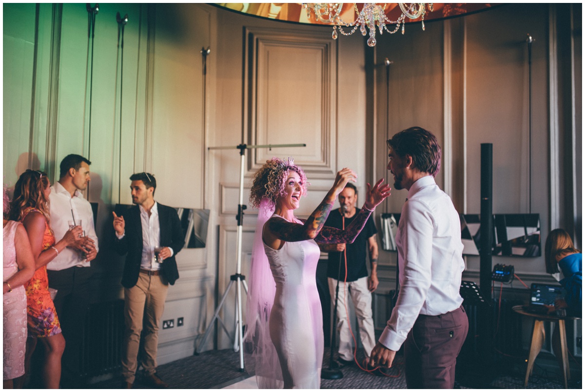 Tattooed bride and groom in pink suit start their First Dance in Chester.