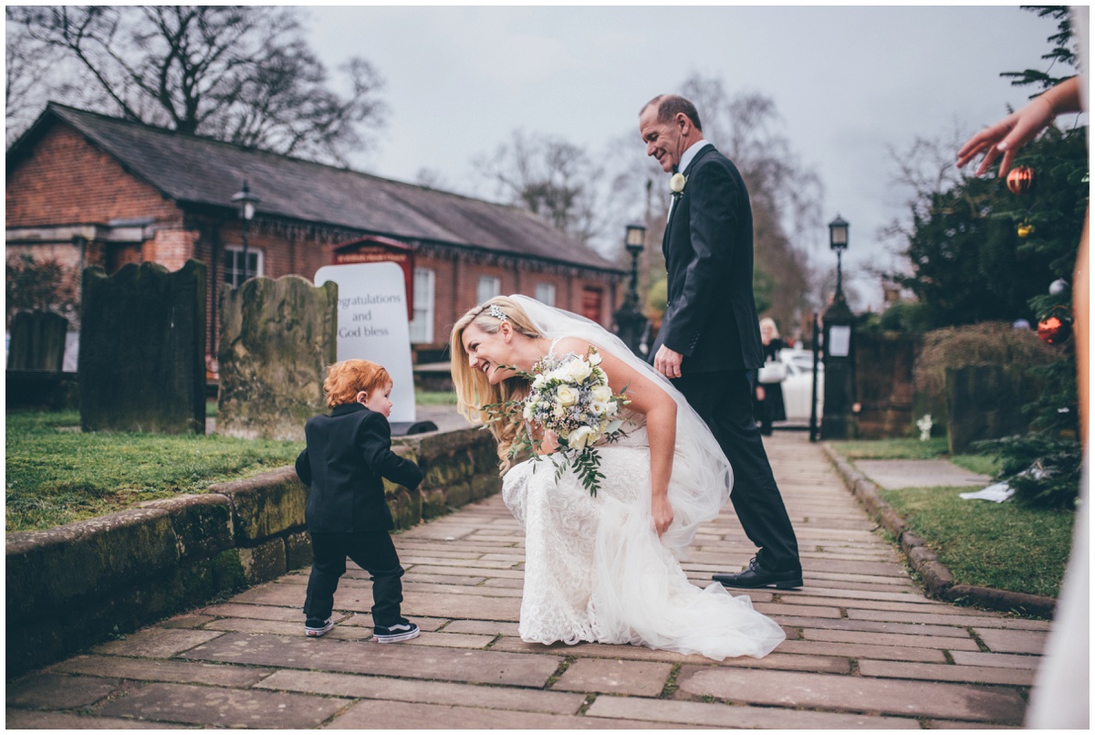 Bride greets her son when she arrives at the church in Cheshire.
