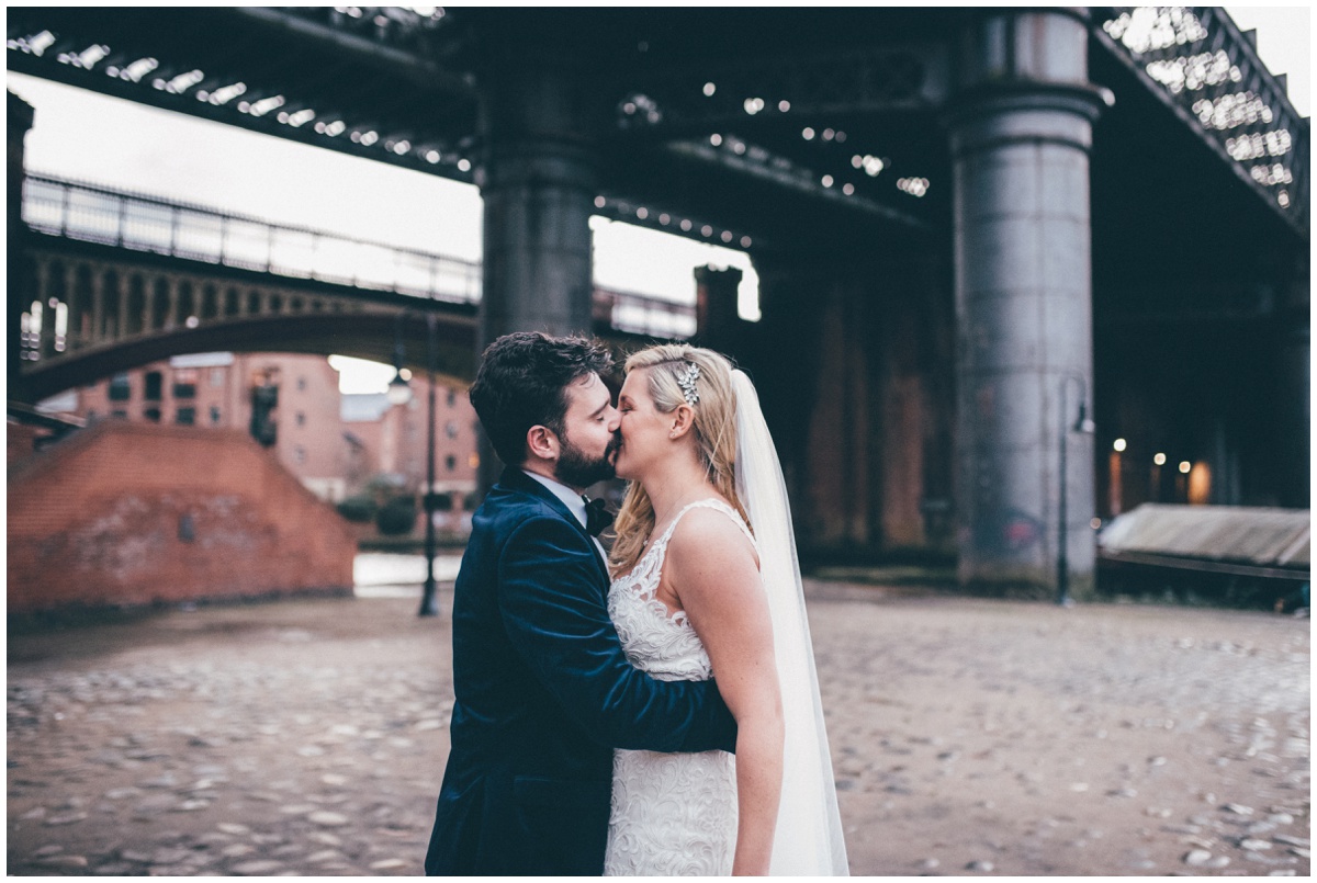 New Years Eve bride and groom pose for their wedding photographs in Castlefield, Manchester.