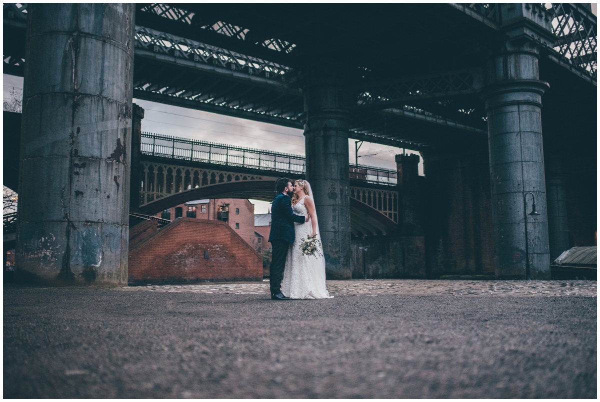 New Years Eve bride and groom pose for their wedding photographs in Castlefield, Manchester.