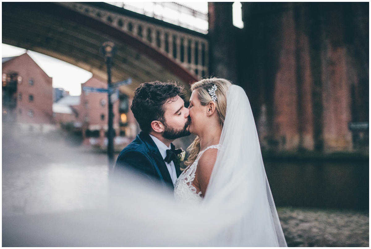 New Years Eve bride and groom pose for their wedding photographs in Castlefield, Manchester City Centre.