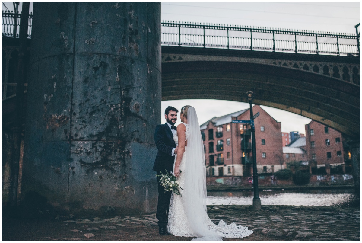 New Years Eve bride and groom pose for their wedding photographs in Castlefield, Manchester City Centre.