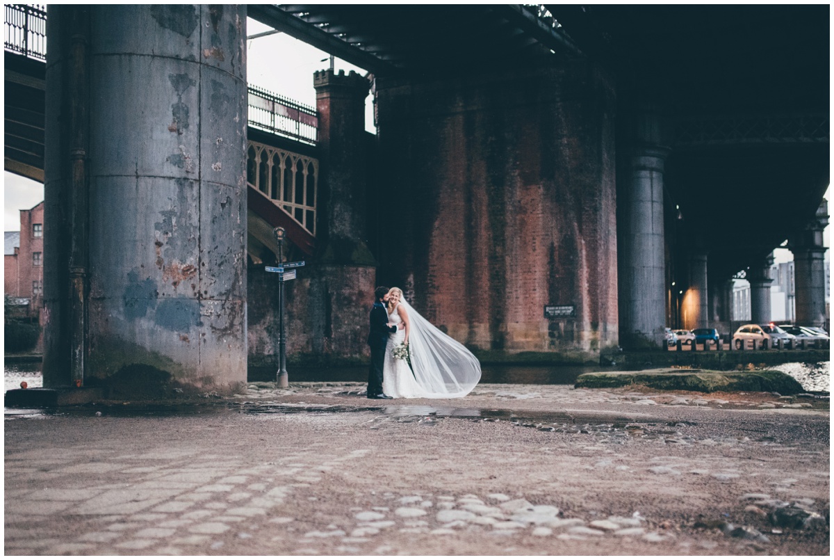 New Years Eve bride and groom pose for their wedding photographs in Castlefield, Manchester City Centre.