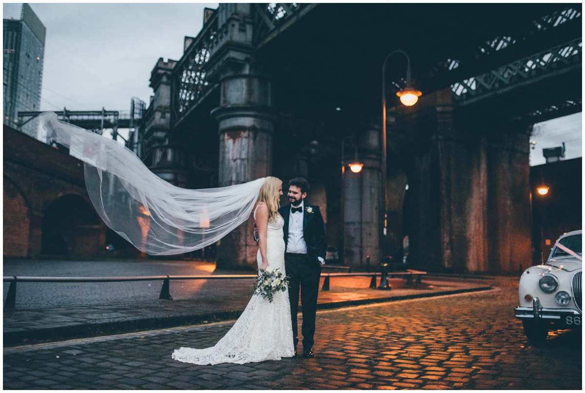New Years Eve bride and groom pose for their wedding photographs in Castlefield, Manchester City Centre.