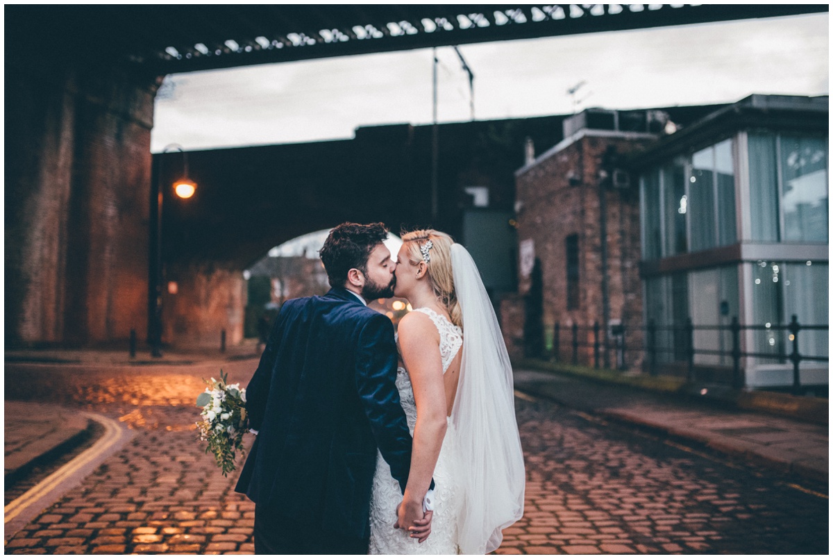 New Years Eve bride and groom pose for their wedding photographs in Castlefield, Manchester City Centre.