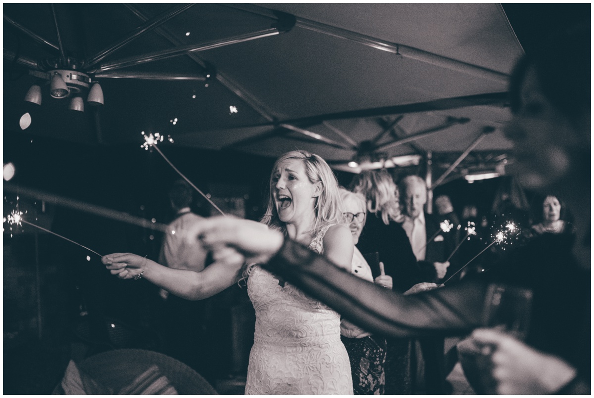 Wedding guests celebrate the New Years with sparklers at New Years Eve wedding at Great John Street Hotel in Manchester.