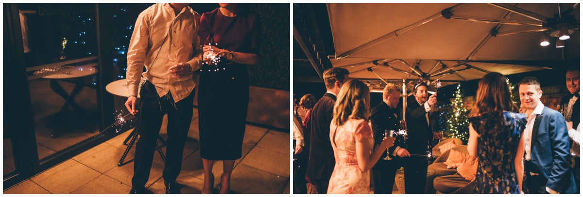 Wedding guests celebrate the New Years with sparklers at New Years Eve wedding at Great John Street Hotel in Manchester.