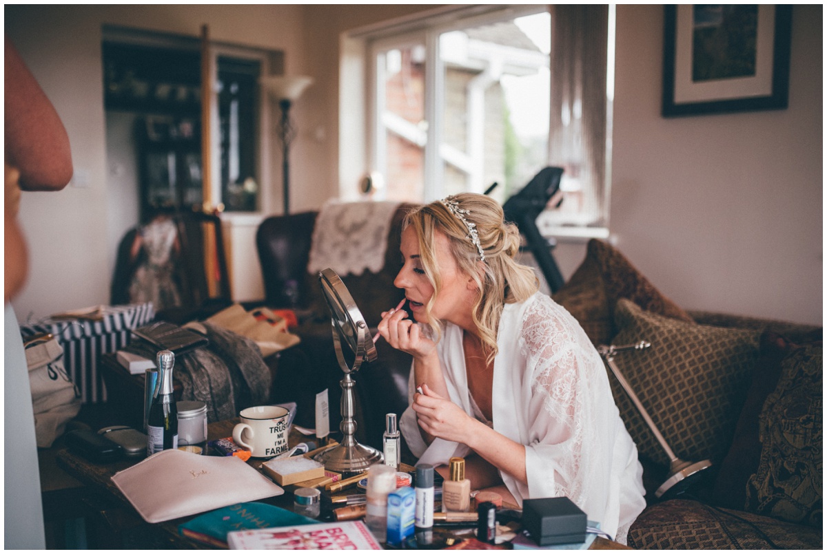 Bride puts on her own make-up on the morning of her own wedding in Staffordshire.