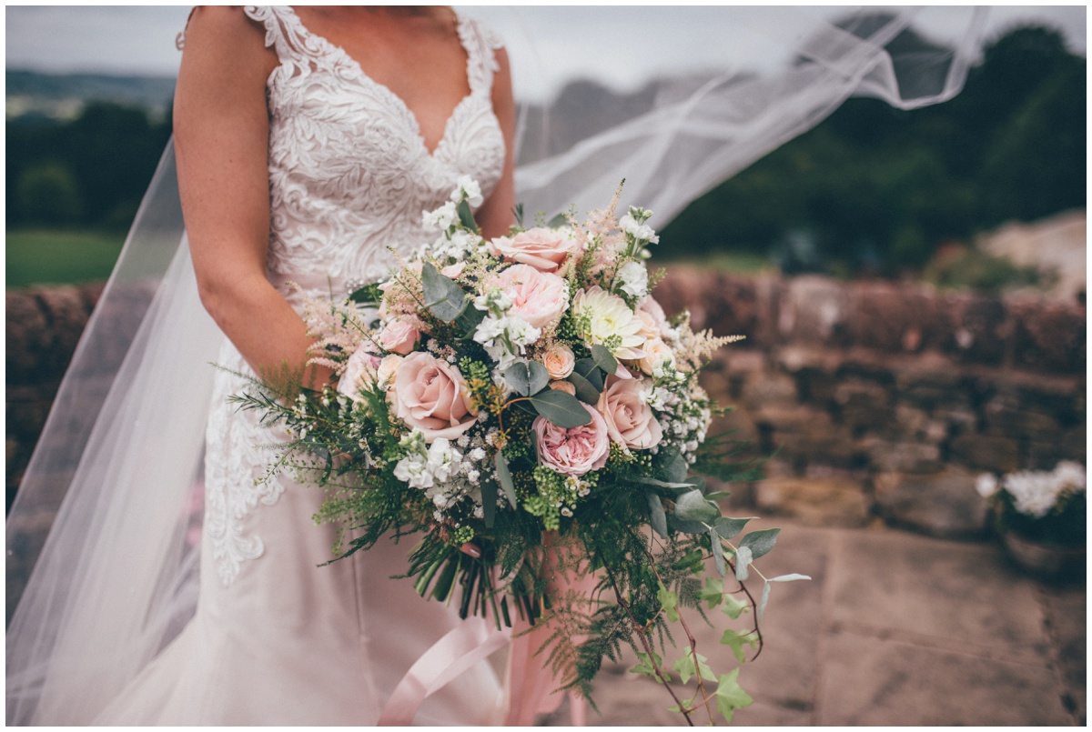 The Staffordshire bride-to-be holds her stunning pastel coloured wedding bouquet.