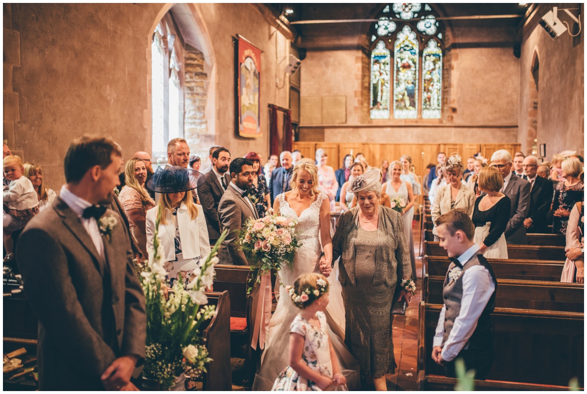 Bride walks down the aisle towards her husband-to-be in St Matthews church in Leek, Staffordshire.