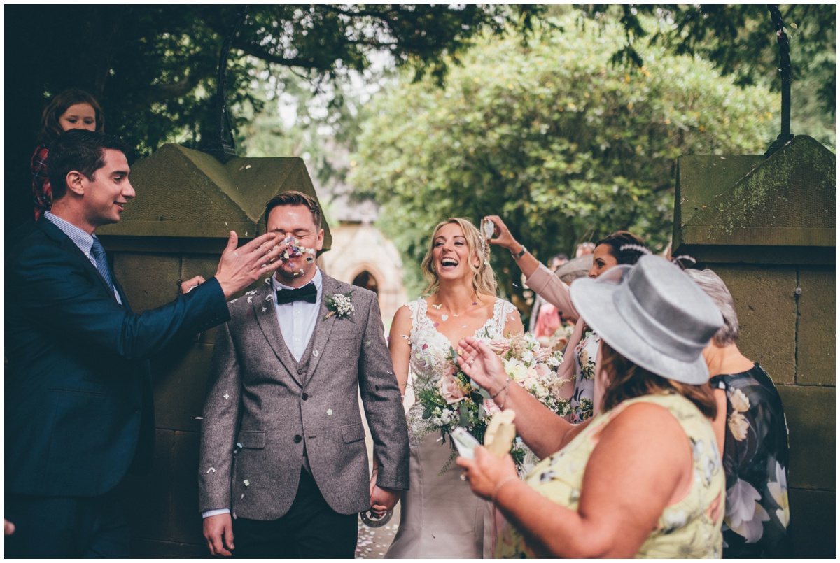 Wedding guest throws confetti in the groom's face after their wedding at St. Matthews church in Leek.