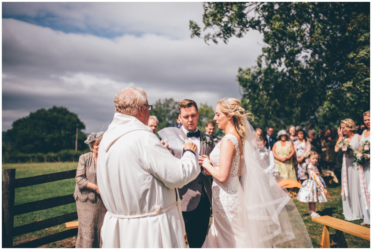 Wedding blessing in a sunny field in summer.